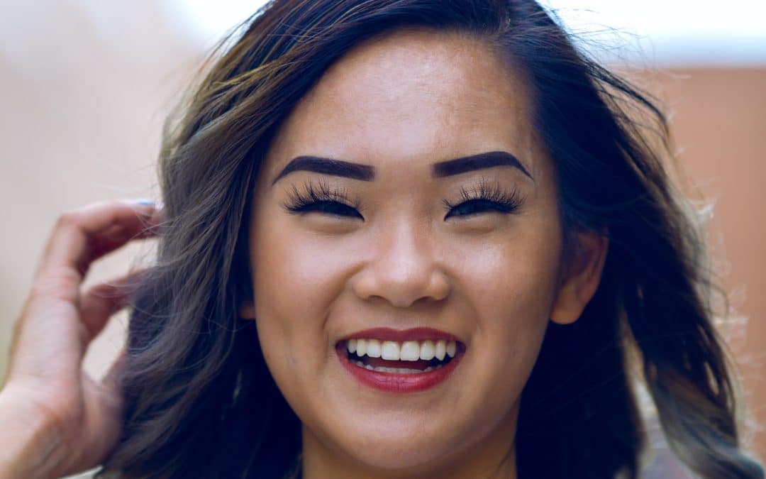 Asian woman smiles widely after getting teeth whitening in Oak Park, IL