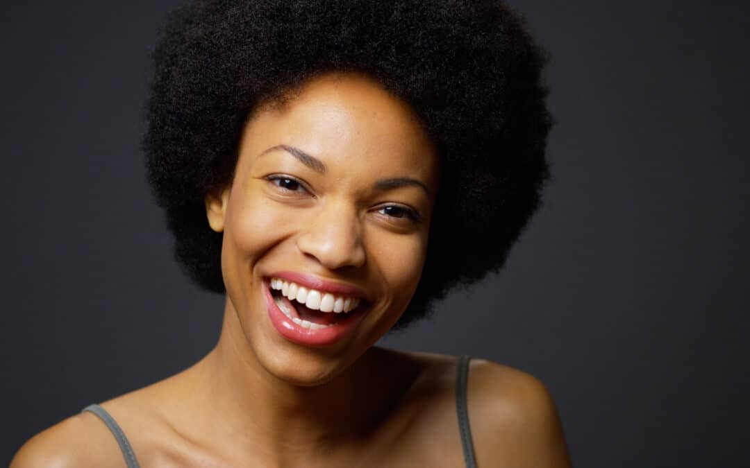 portrait of black woman smiling after cosmetic dentistry treatment