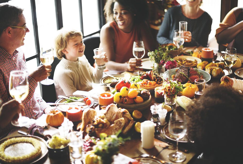 family around table at Thanksgiving