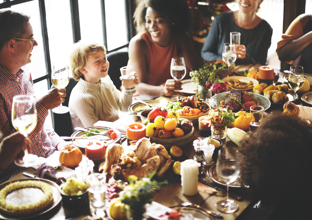 family around table at Thanksgiving